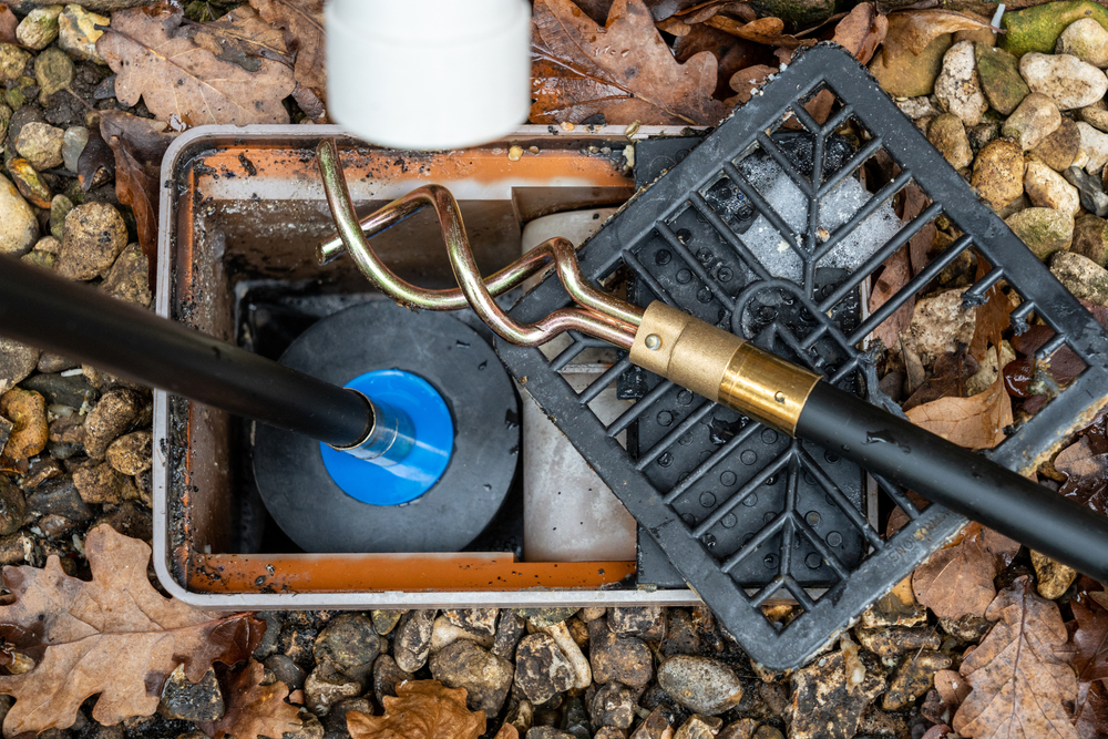 Drain rods clearing a blocked outside drain