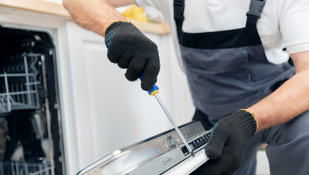 Engineer repairing a dishwasher