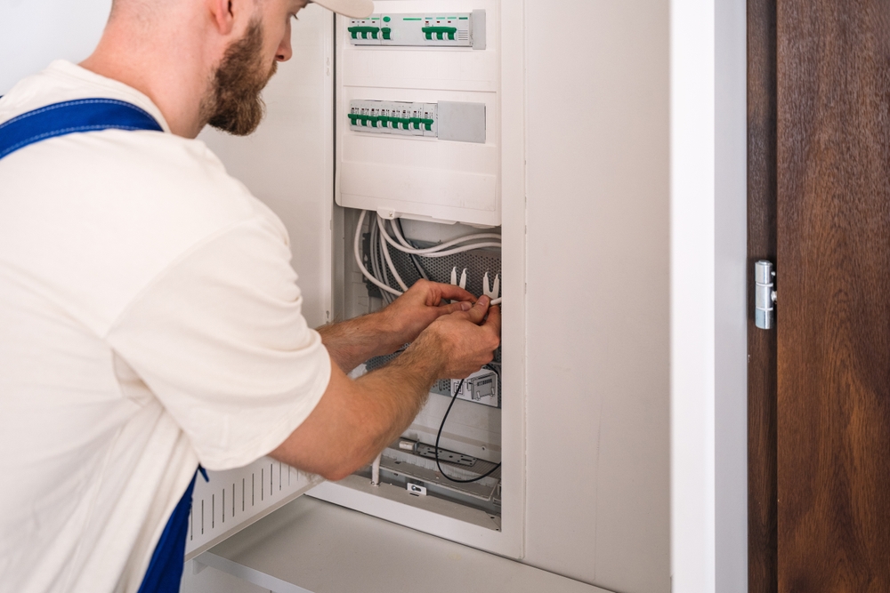Electrician working on a fuse board