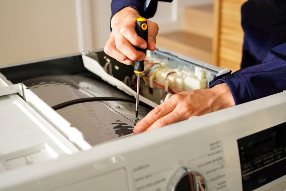Engineer repairing a washing machine