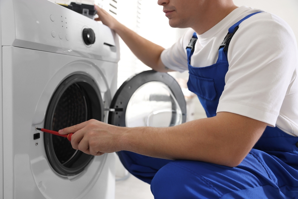 Engineer repairing a washing machine
